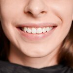 Macro photography of a beautiful female smile with white healthy teeth